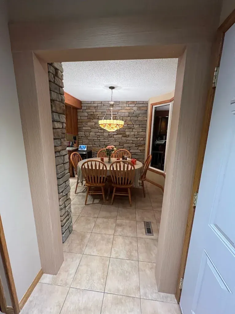 Wide painted custom casing around an opening into a dining room