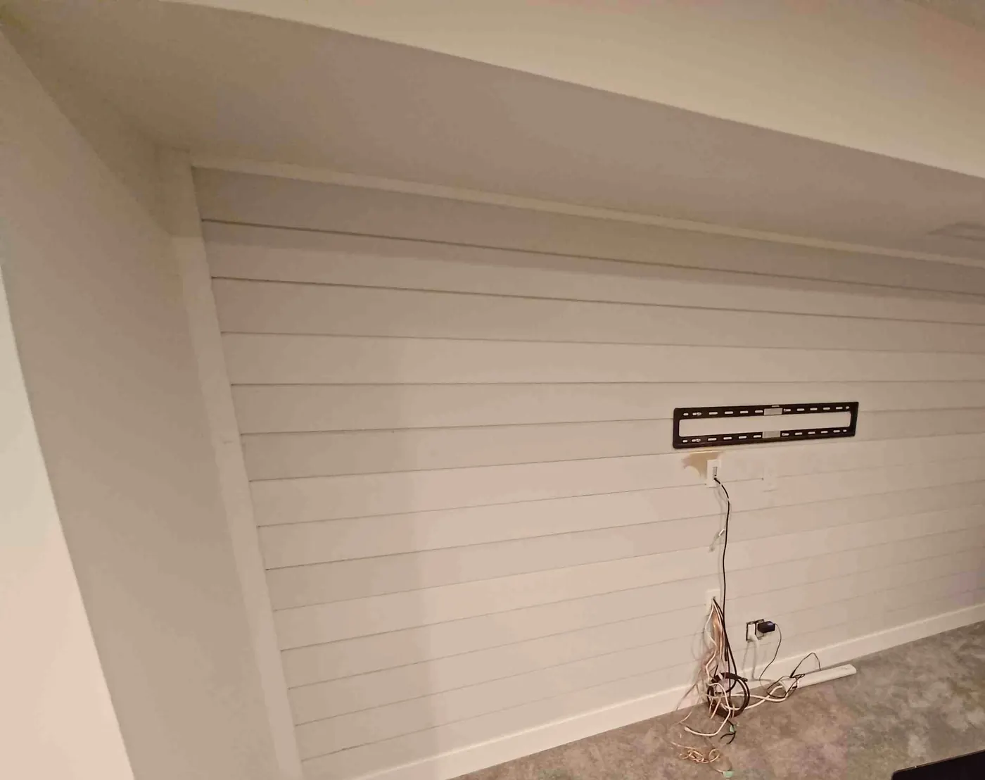 Painted shiplap feature wall ready for a wall-mounted TV