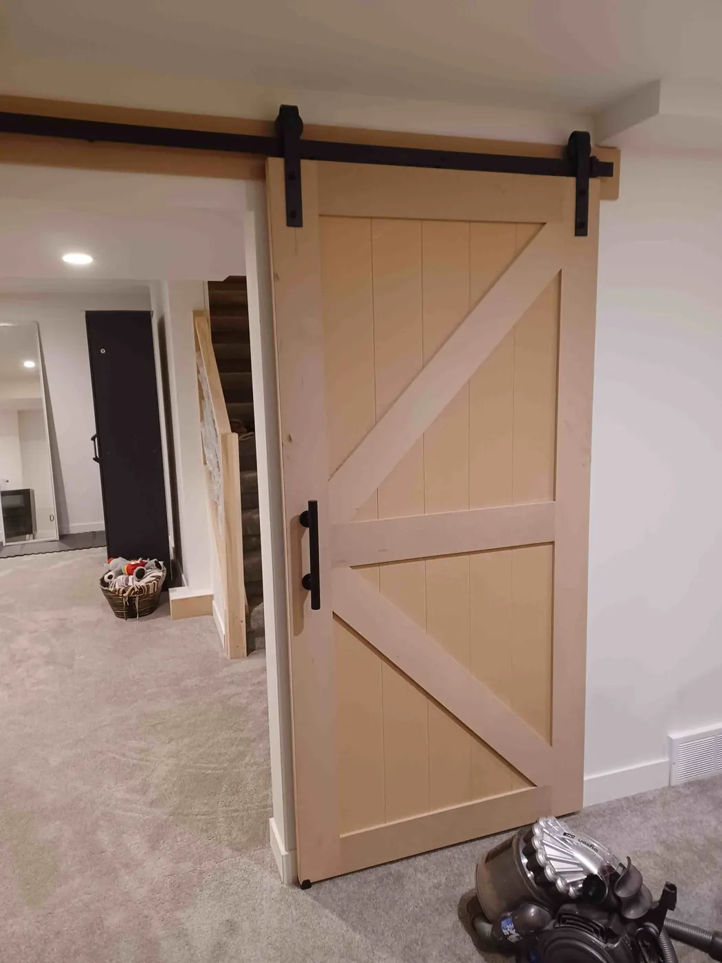 Sliding barn door with an X brace on black track hardware