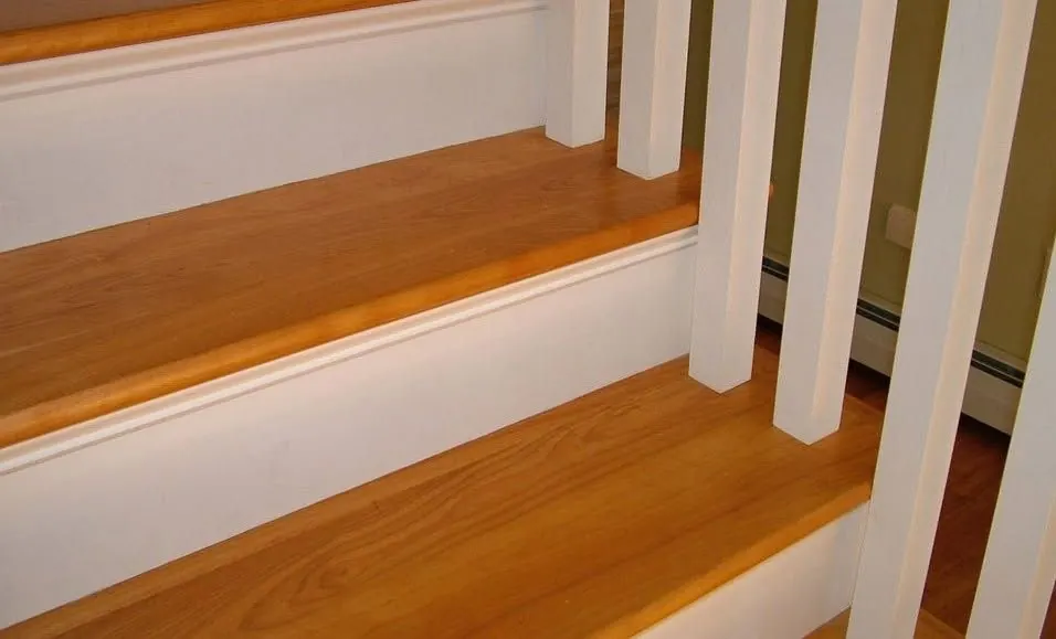 Square white spindles on stained wood stair treads